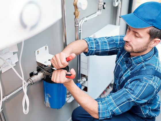 plumber installing a whole water filtration system