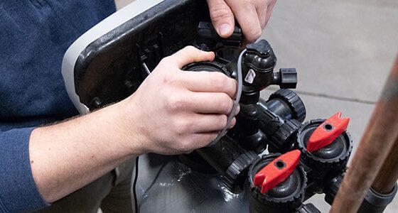 Technician repairing a water softener